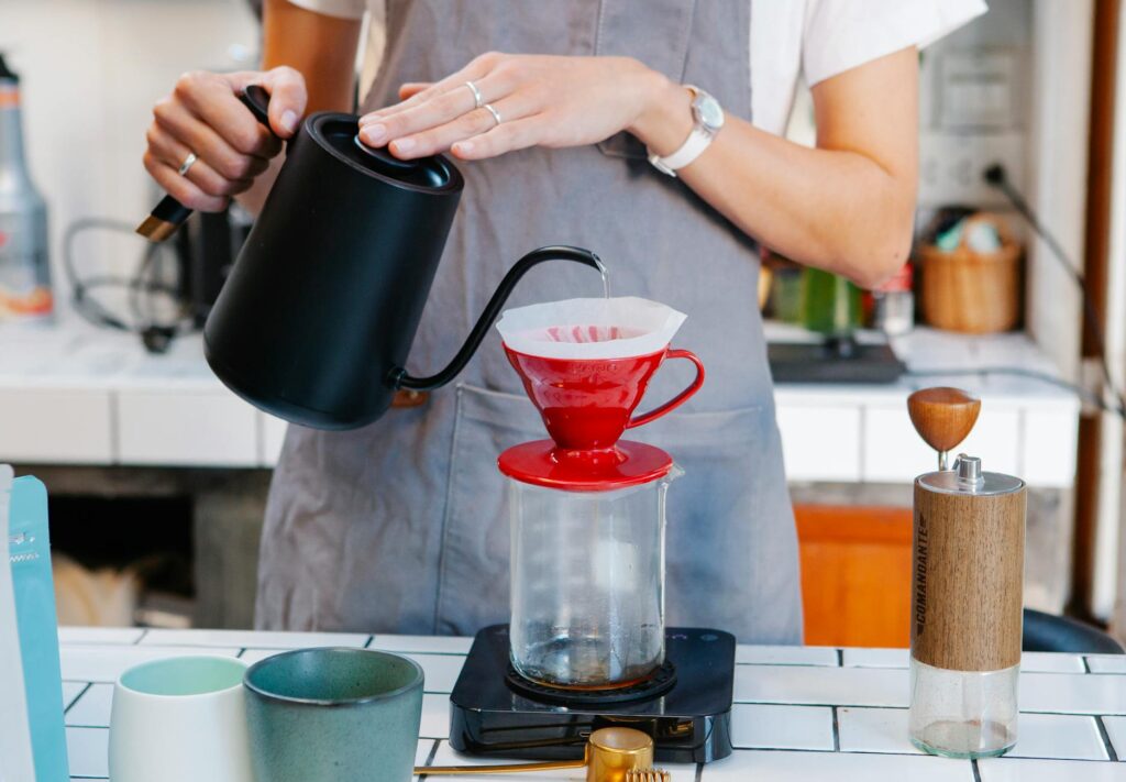 woman preparing coffee with filter dripper